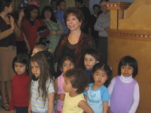 Children visiting with Isabelle Allende